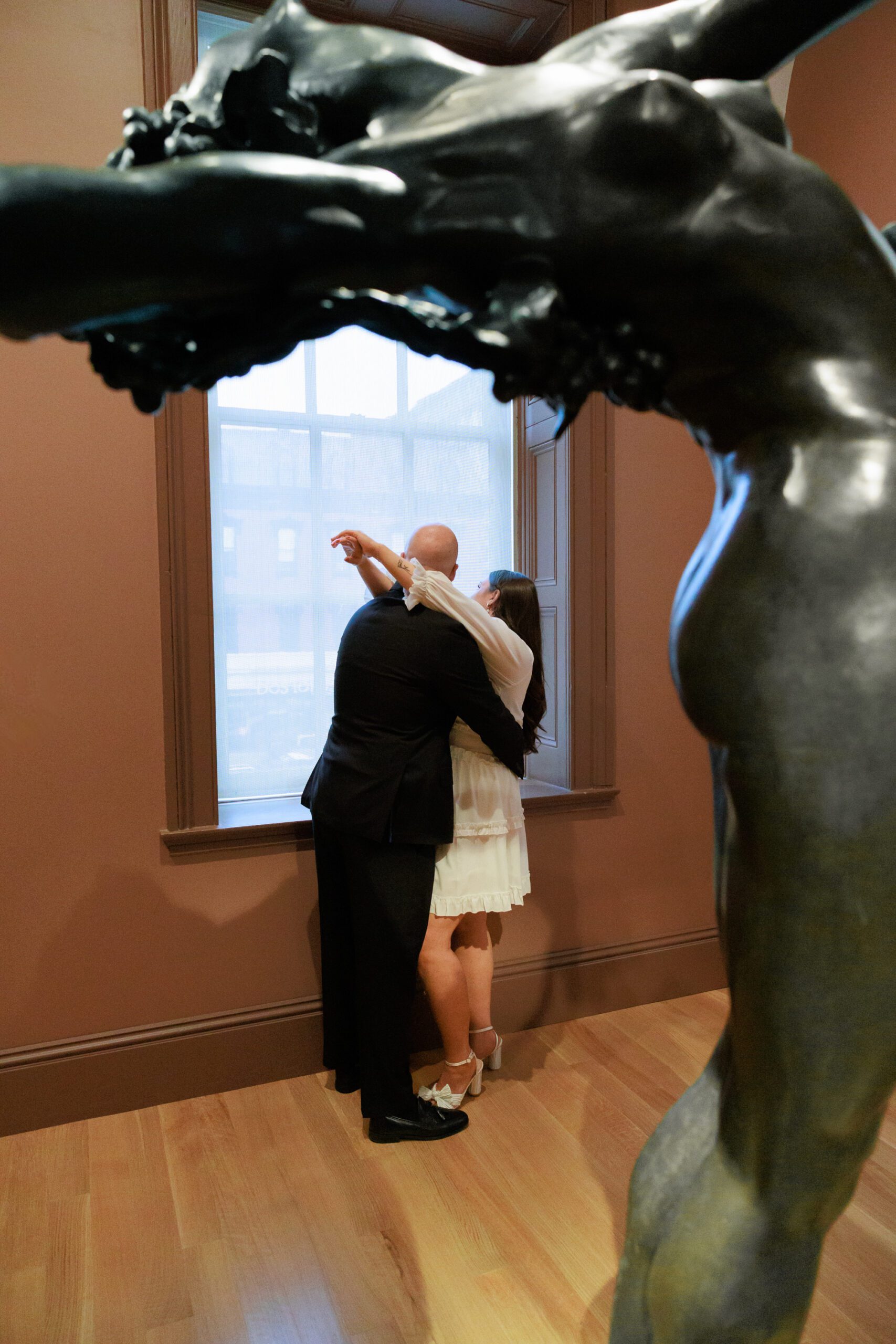 A couple embraces for their engagement photos at the National Portrait Gallery in Washington DC.