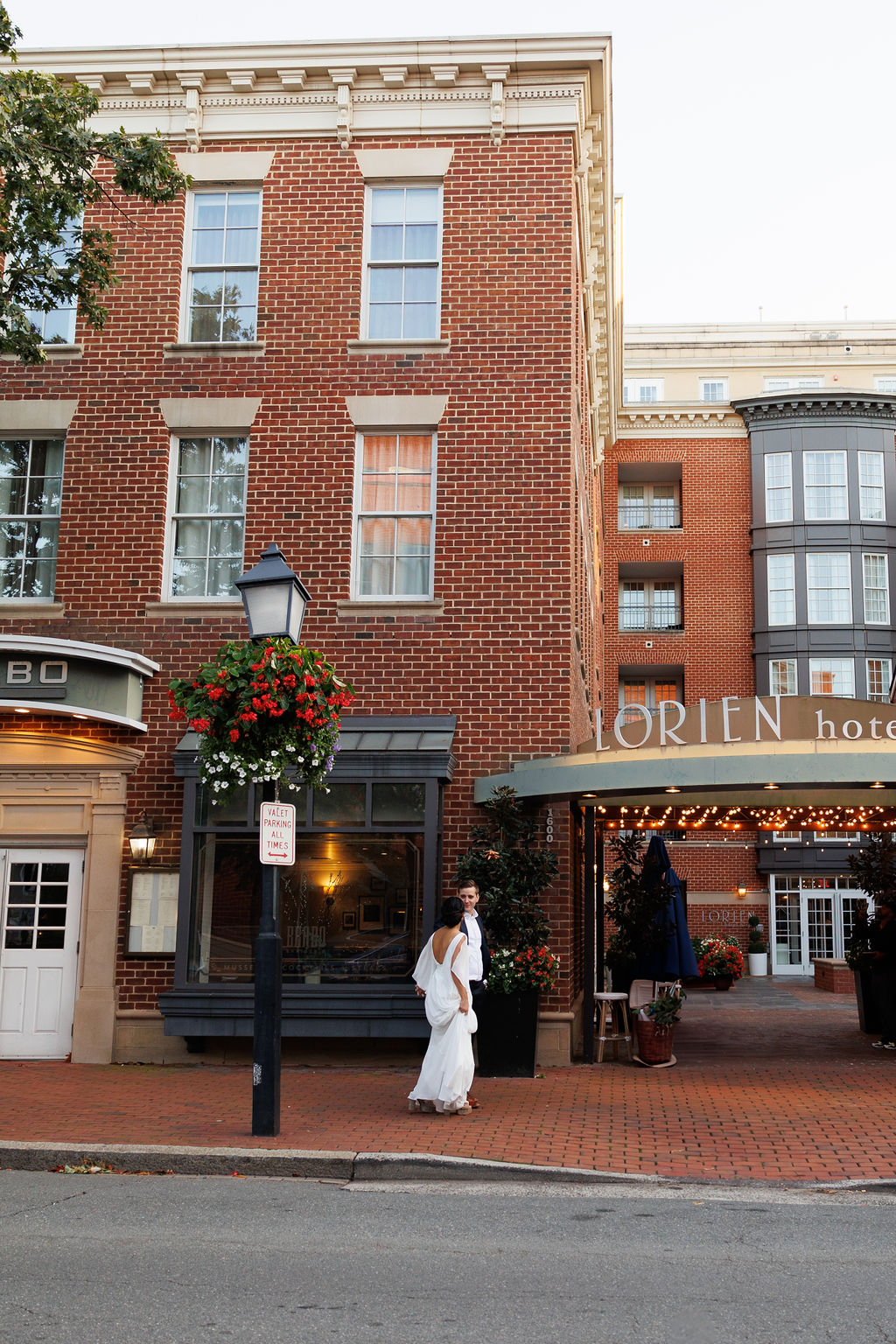 Newlyweds walk together on the brick pathways outside the lorien hotel wedding venue