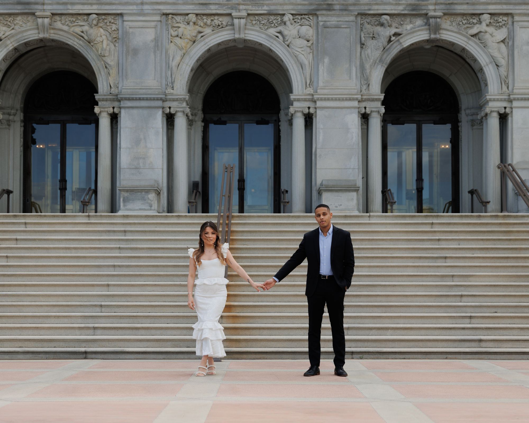 Bride and groom-to-be holding hands.