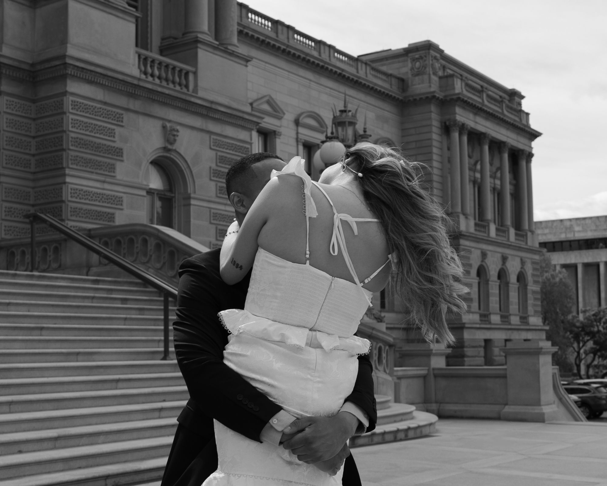 Groom picking up his bride and spinning her around.