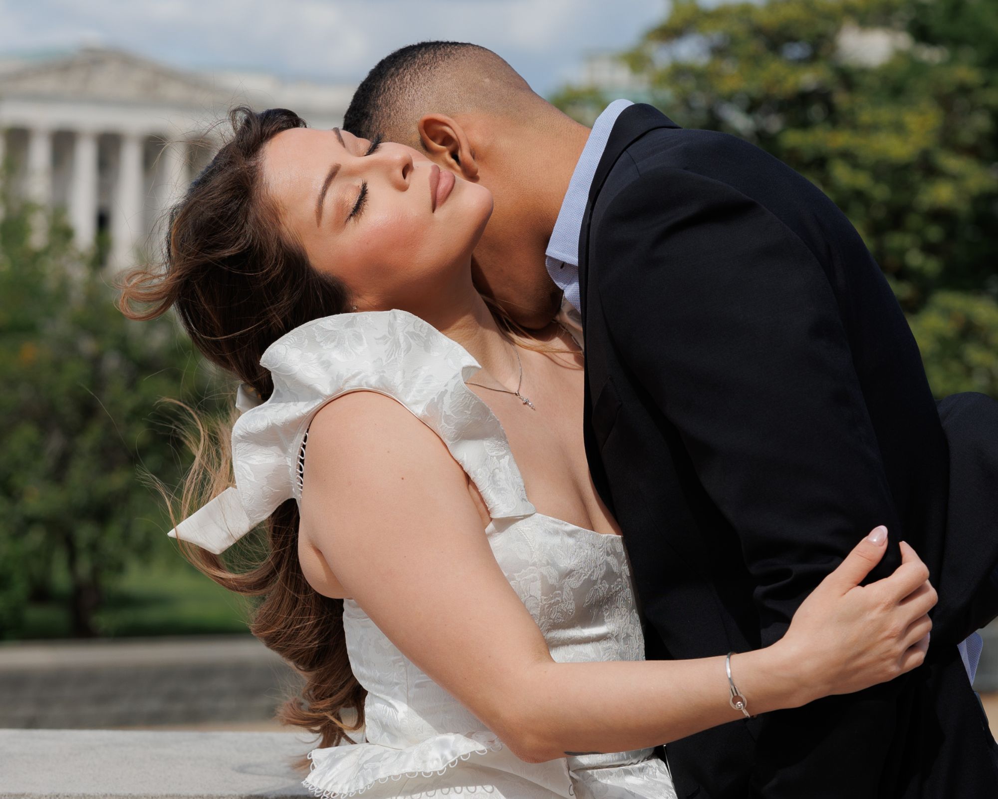 Newly engaged couple sharing a kiss at the Library of Congress.