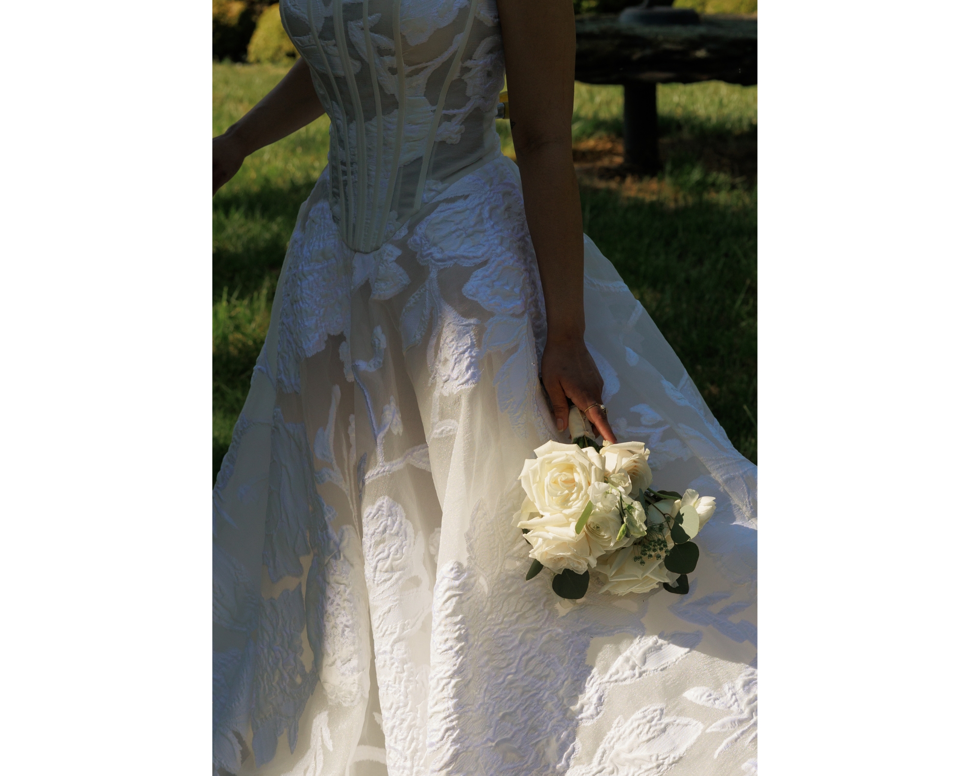 Bridal details featuring an ivory bridal bouquet against a white gown.