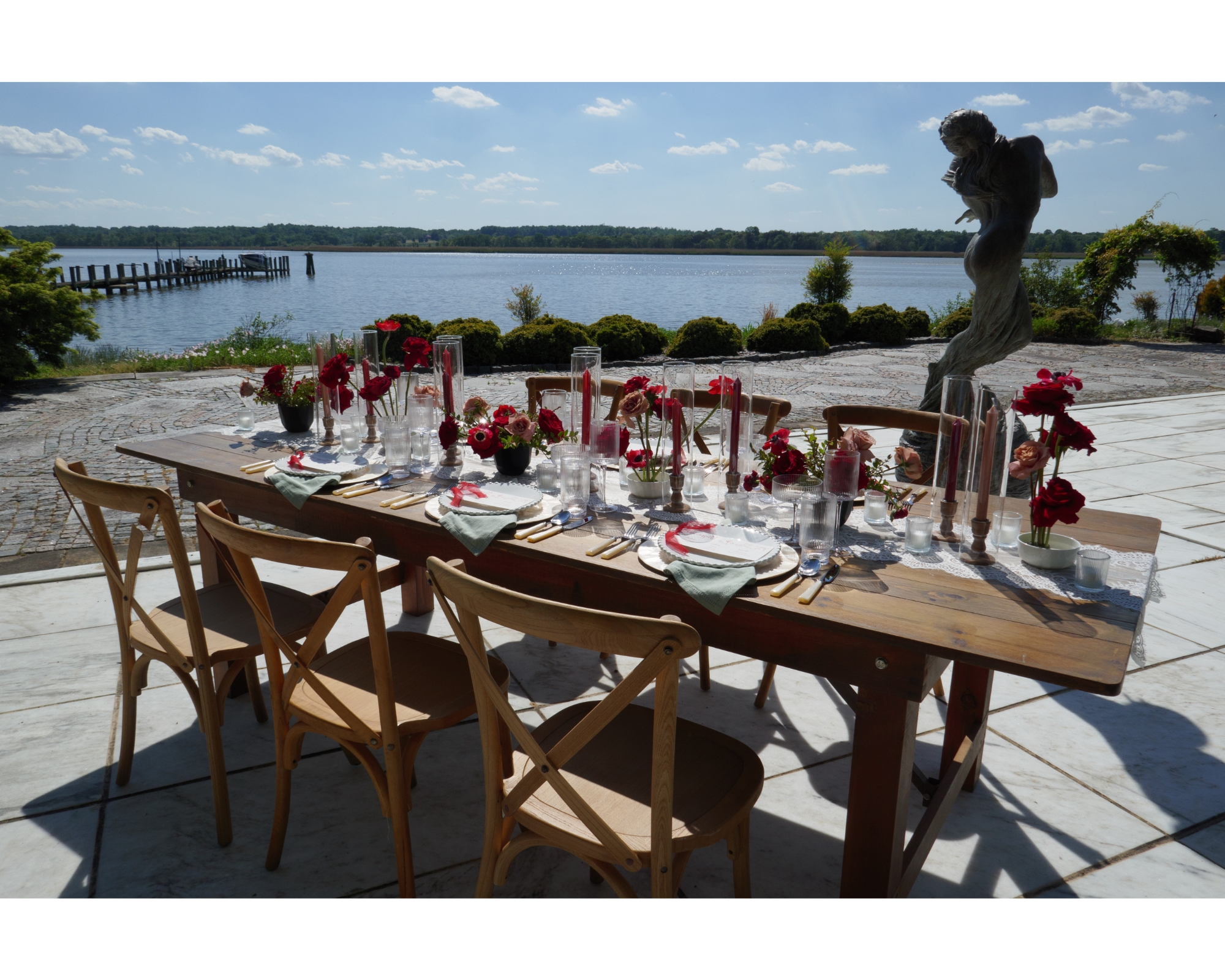 The dinner table set up with red florals and custom letterpress menus.