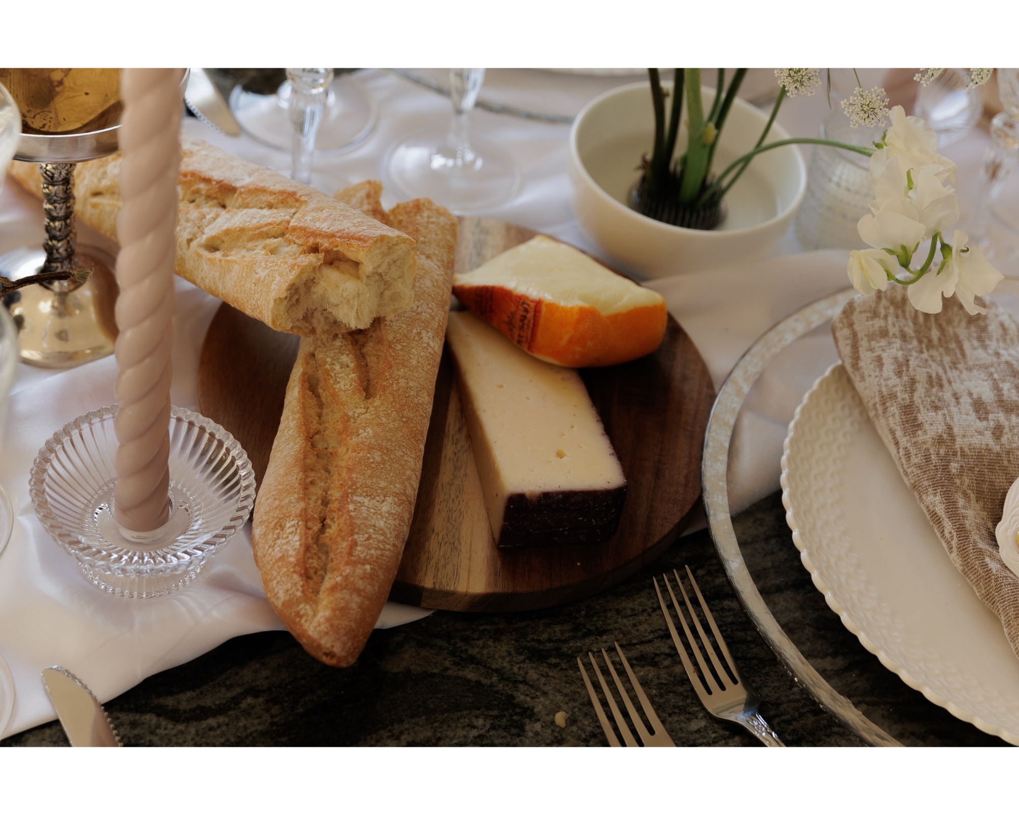 Cheese and bread around the table for guests to share before dinner.