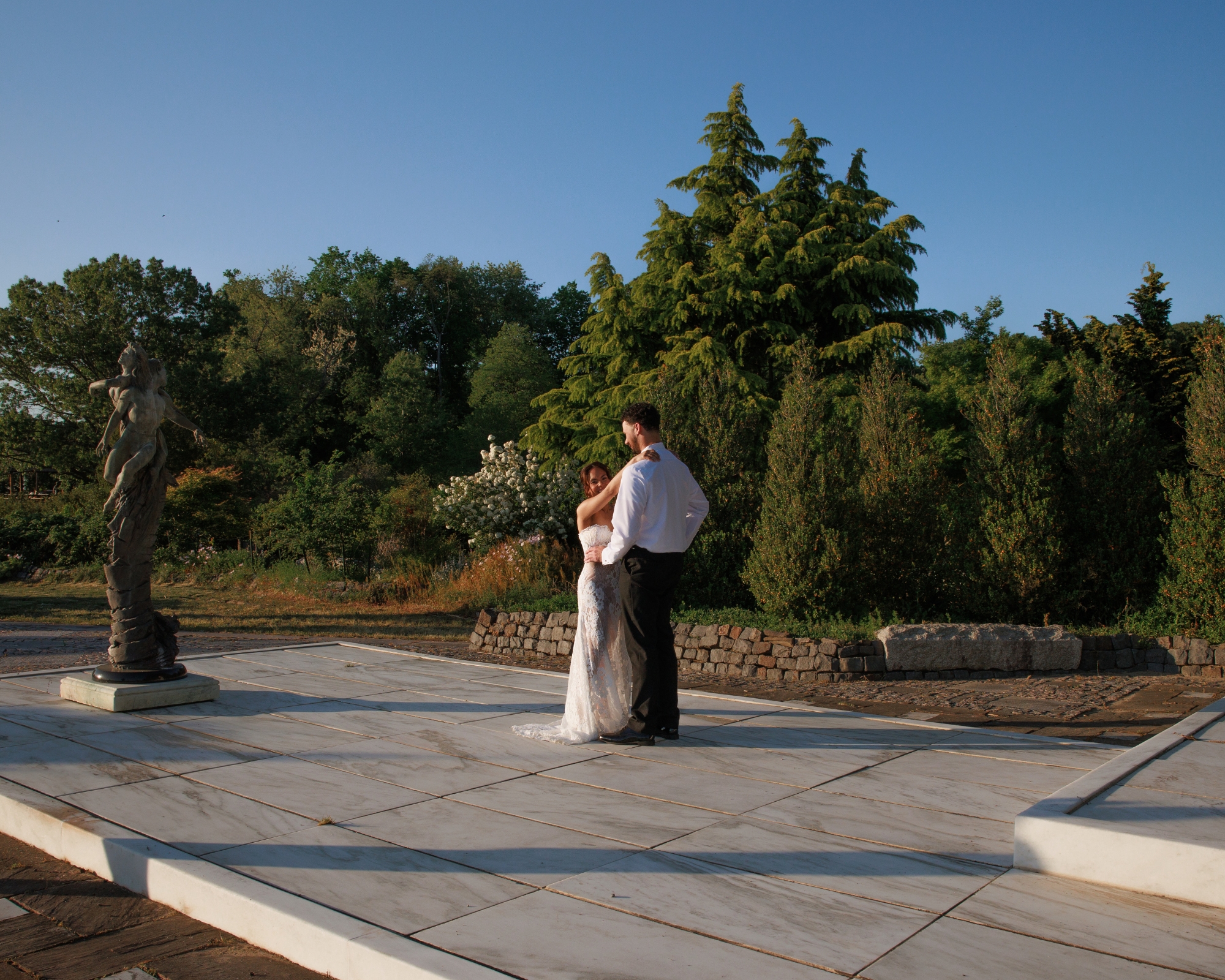 The bride and groom share their first dance, surrounded by their family and friends.