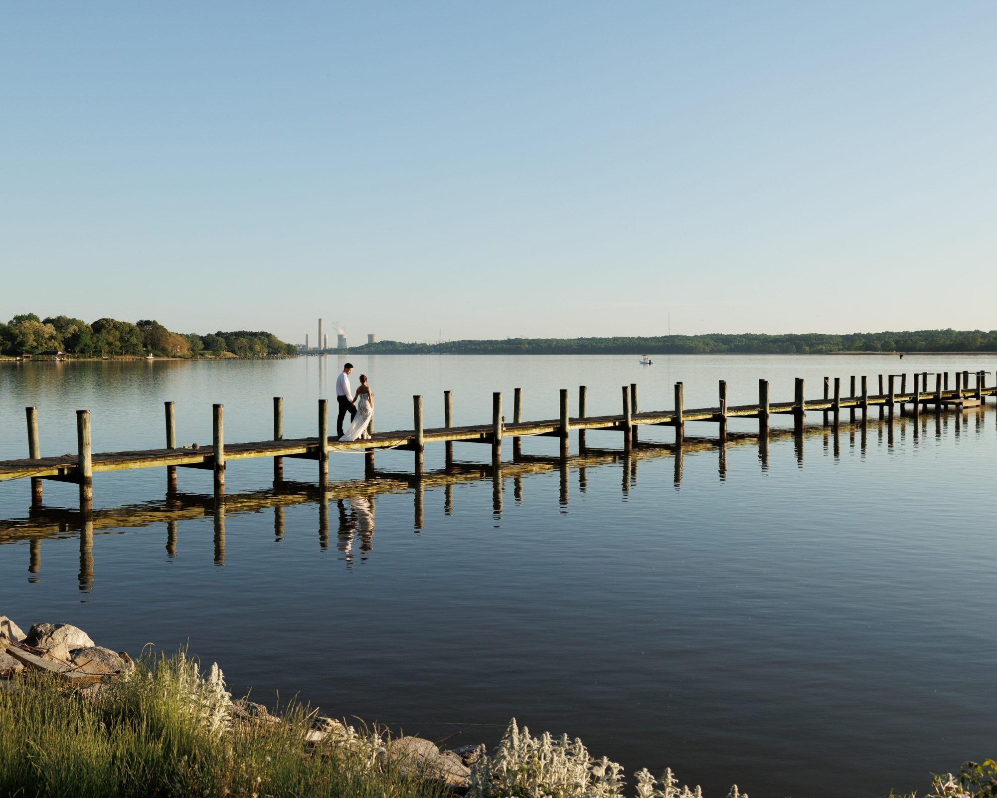 The bride and groom share a private moment together on the dock.