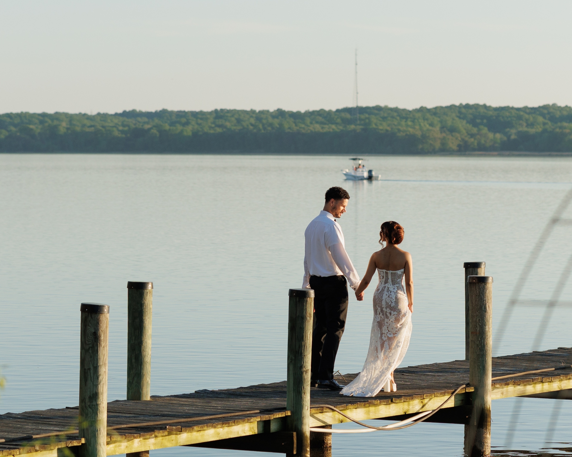 The bride and groom share a private moment together on the dock.