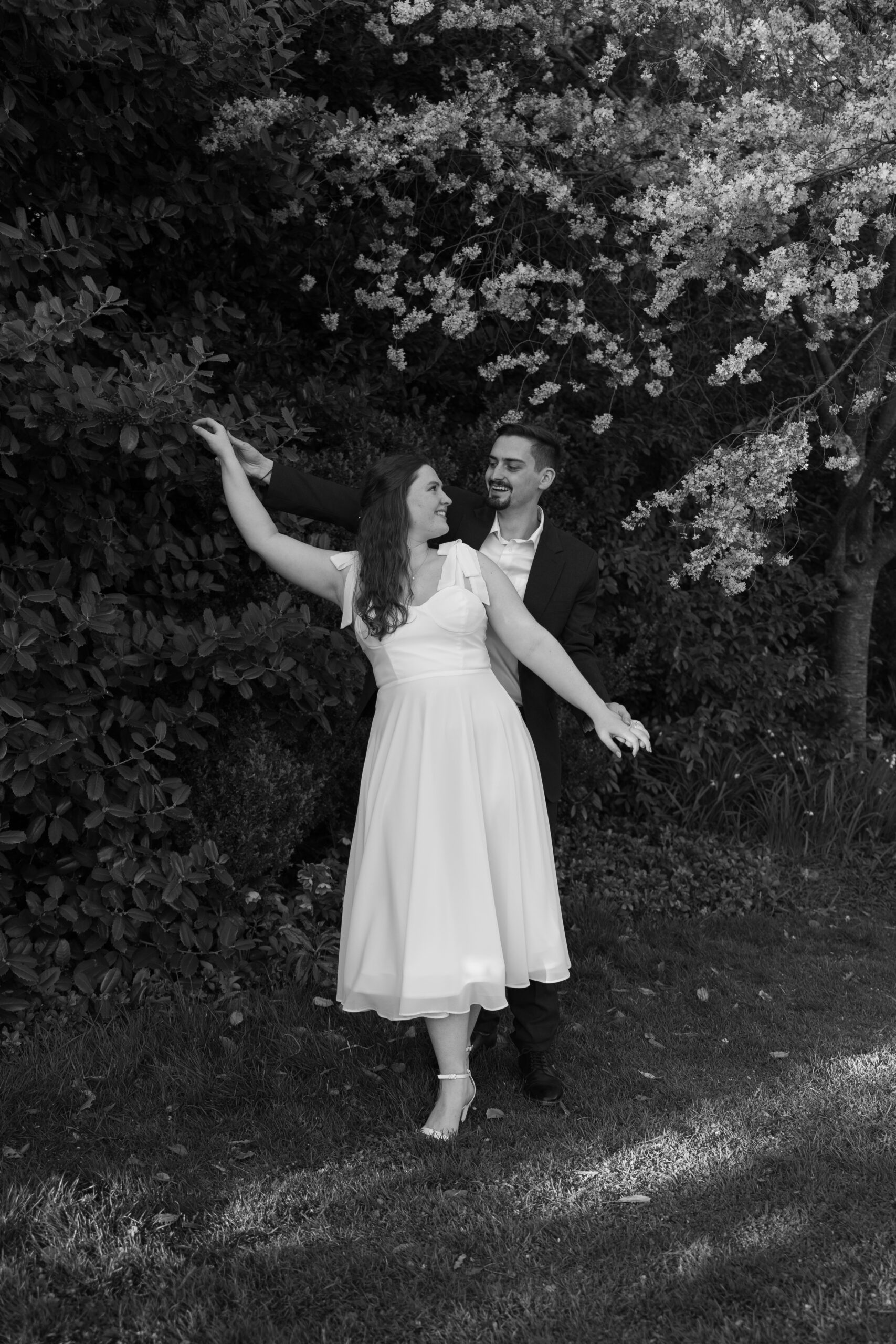 Black and white photo of couple posing together at Bishops Garden at Washington National Cathedral