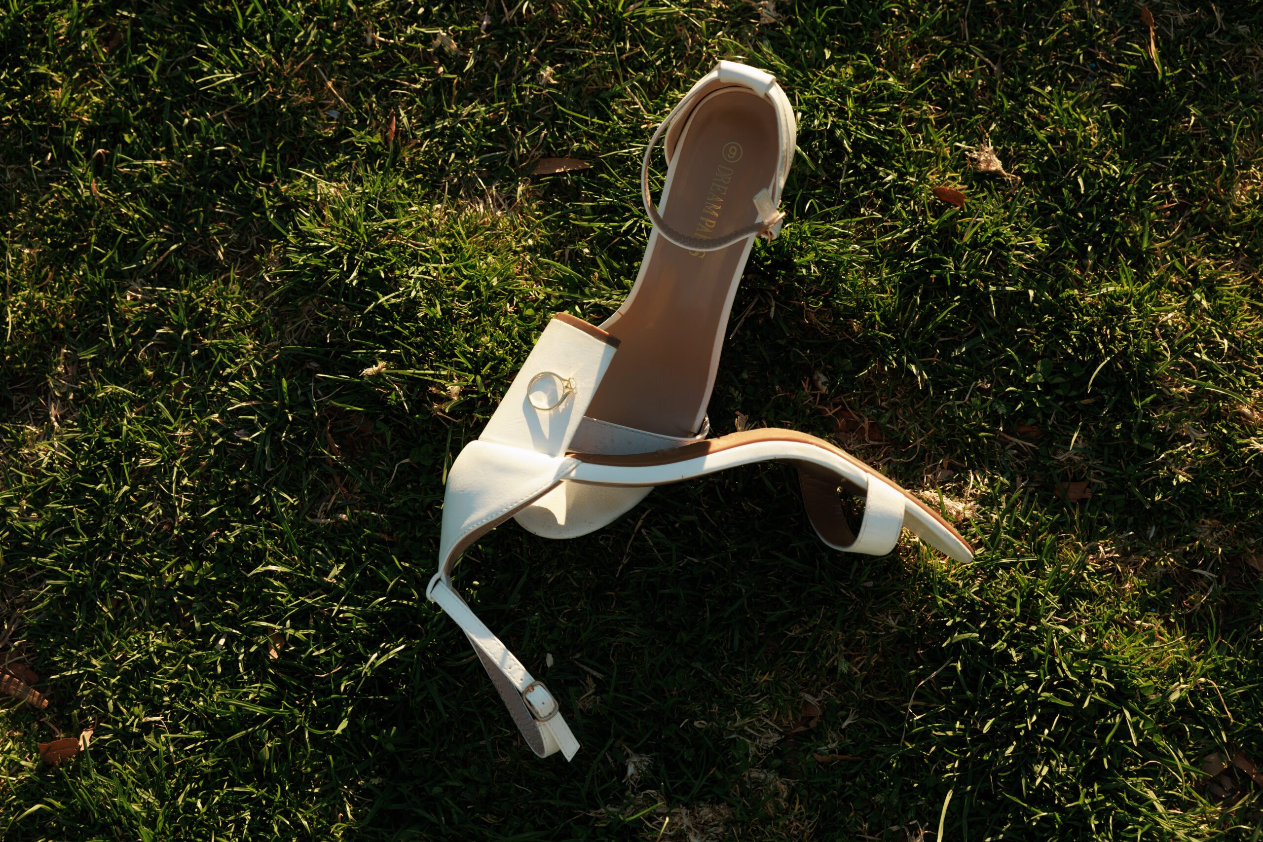 Shoes and engagement ring flat shot on the grass