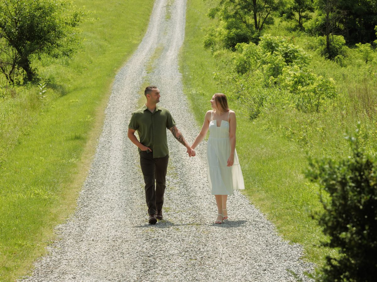 Newly engaged couple walks hand in hand