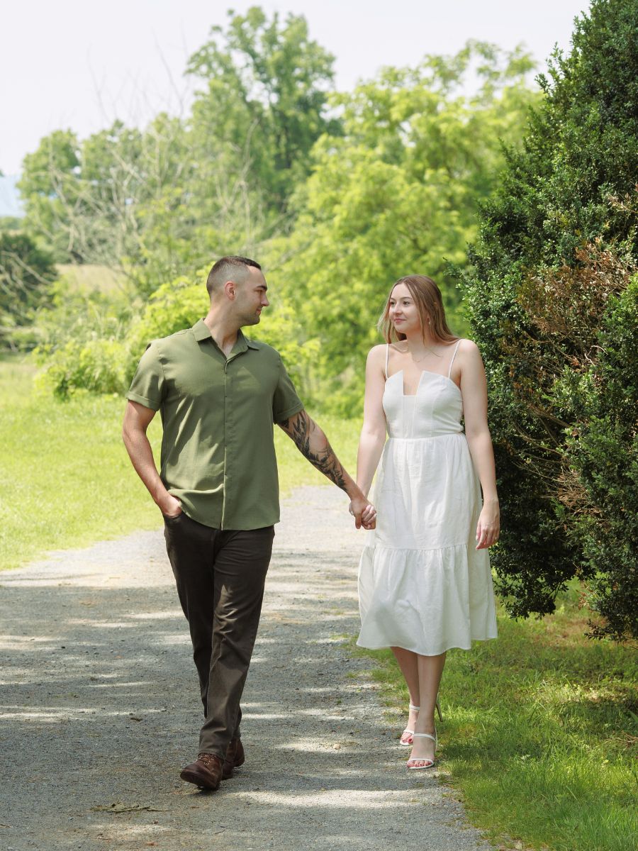 Newly engaged couple walks hand in hand