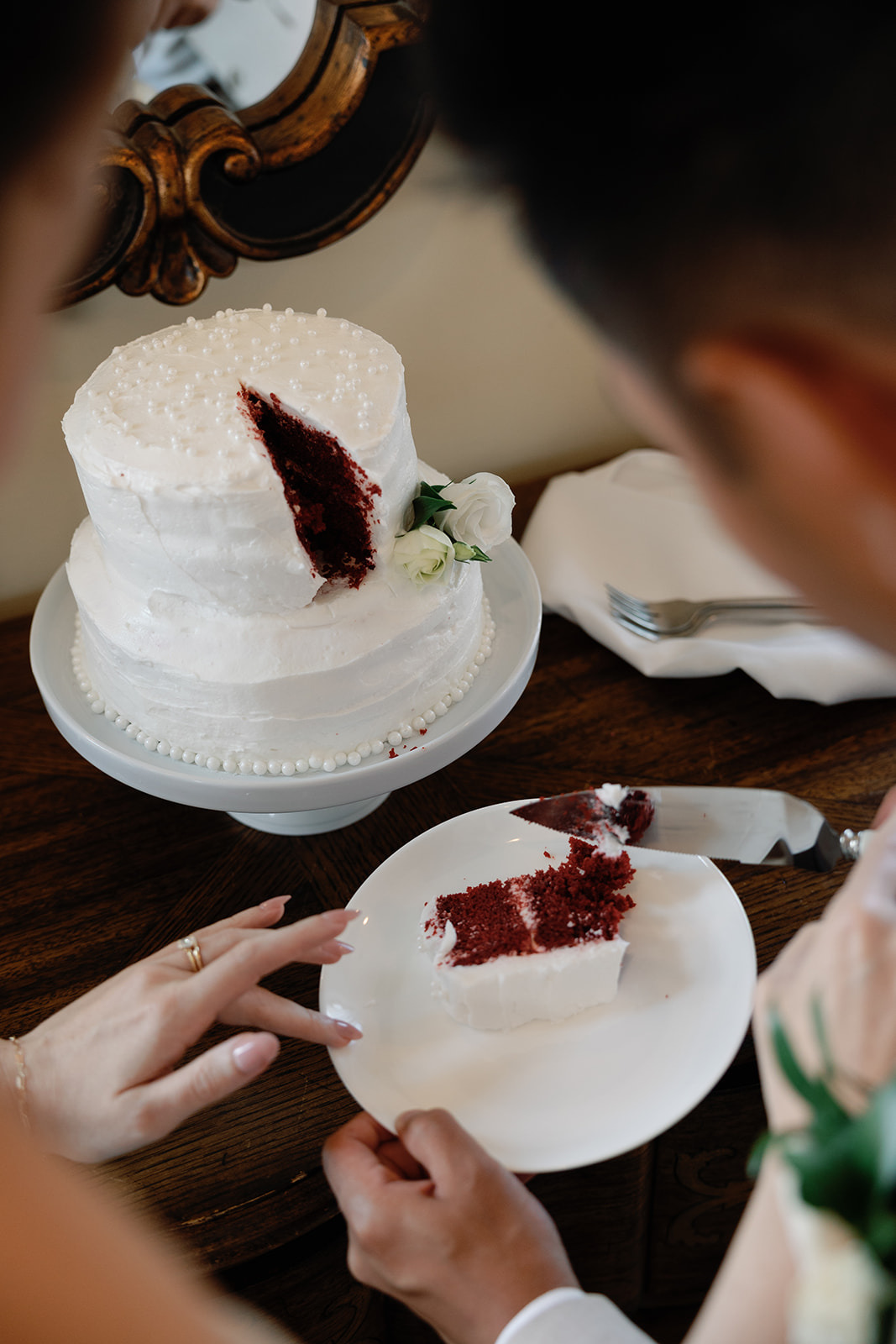 Bride and groom cut the cake at their wedding.