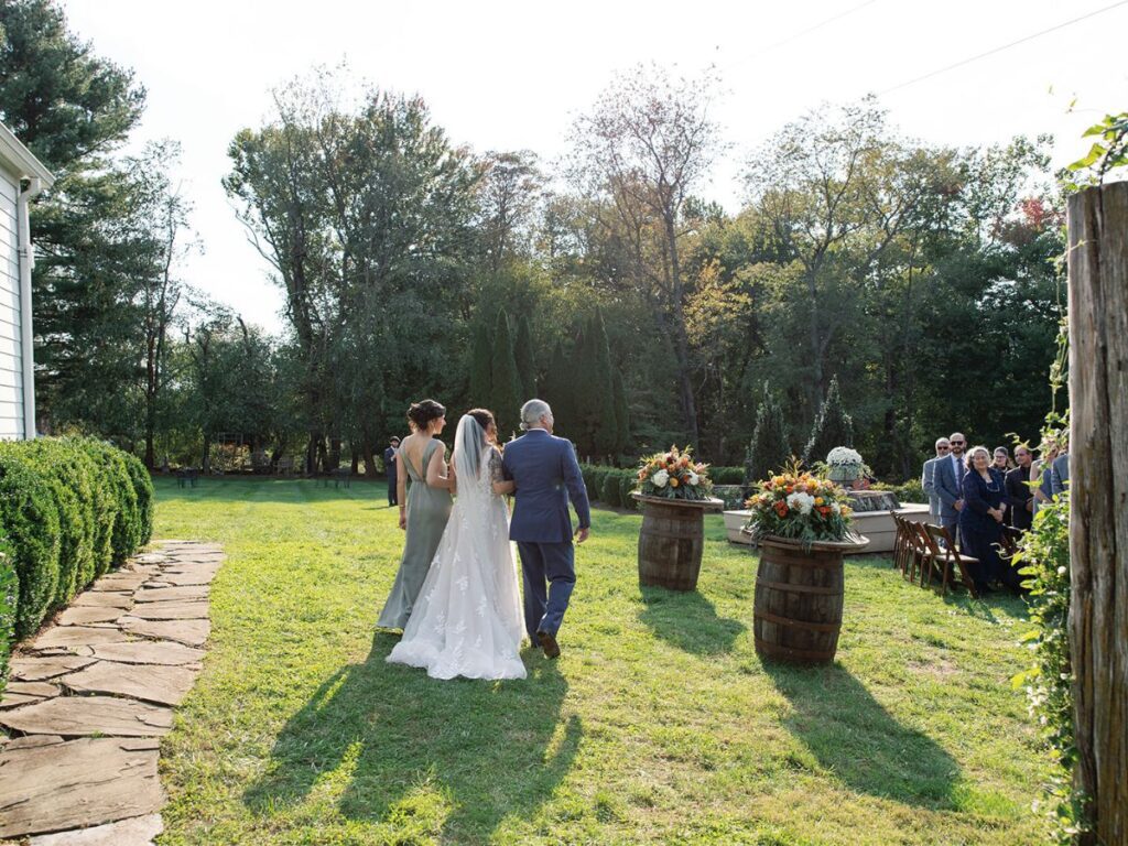 Brides parents walking her down the aisle